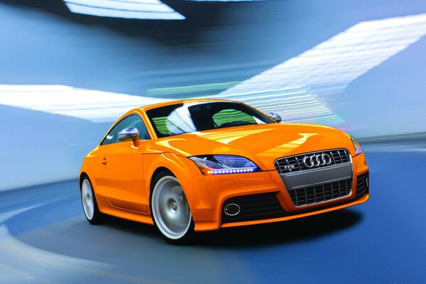 Elegante arancione Audi TT di su sfondo blu