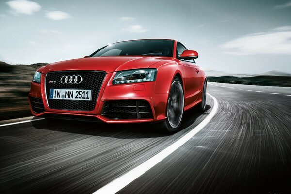 Audi rs5 red color rides on the road