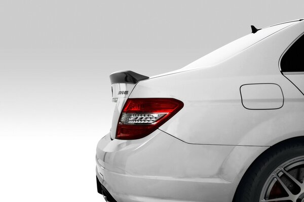 A white car is depicted on a white background