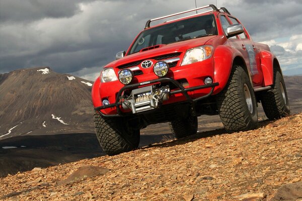 Red Toyota jeep in the mountains