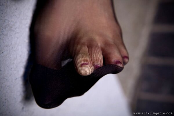 Foot with a bad pediatrician in black tights