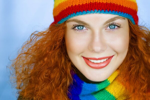 Blue-eyed red-haired girl with a multicolored scarf