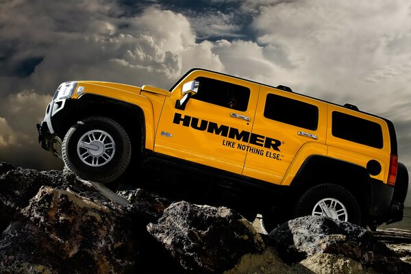 Hummer on the rocks with white clouds