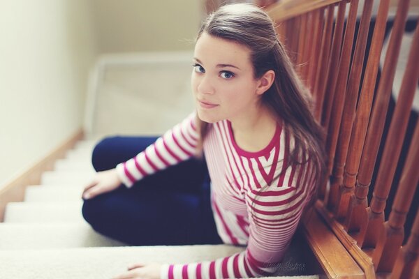 Cute girl sitting on the stairs