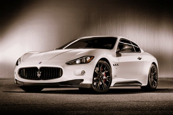 A white sports car on a gray background