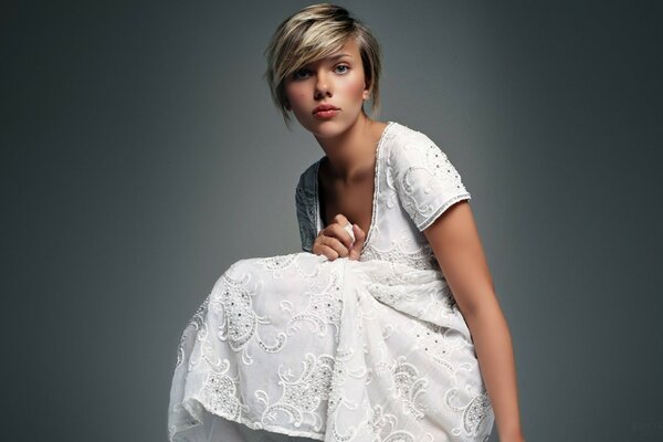 Scarlett Johansson poses in a white dress