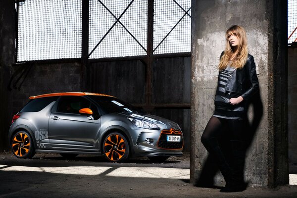 A girl stands by a citroen ds3 racing car