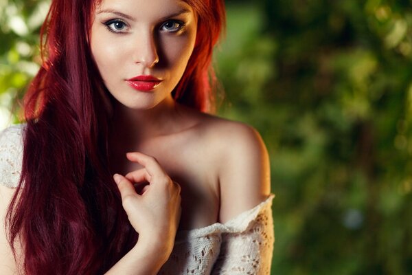 A girl with red hair and a bare shoulder