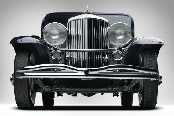 A retro car stands on a white background