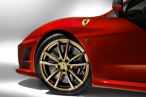 Gold wheels at the red Ferrari