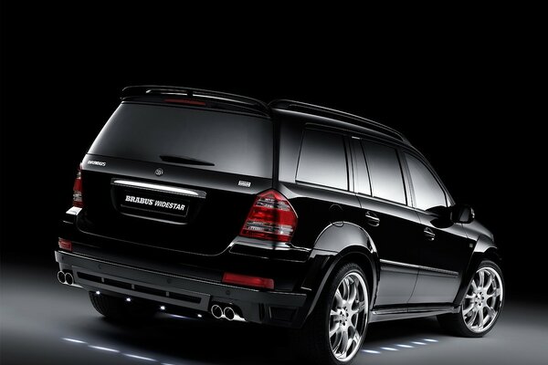 Brabus car is black on a dark background rear view