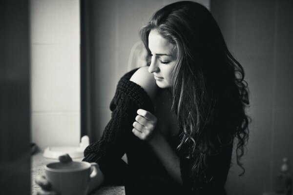 Brunette girl looks out the window