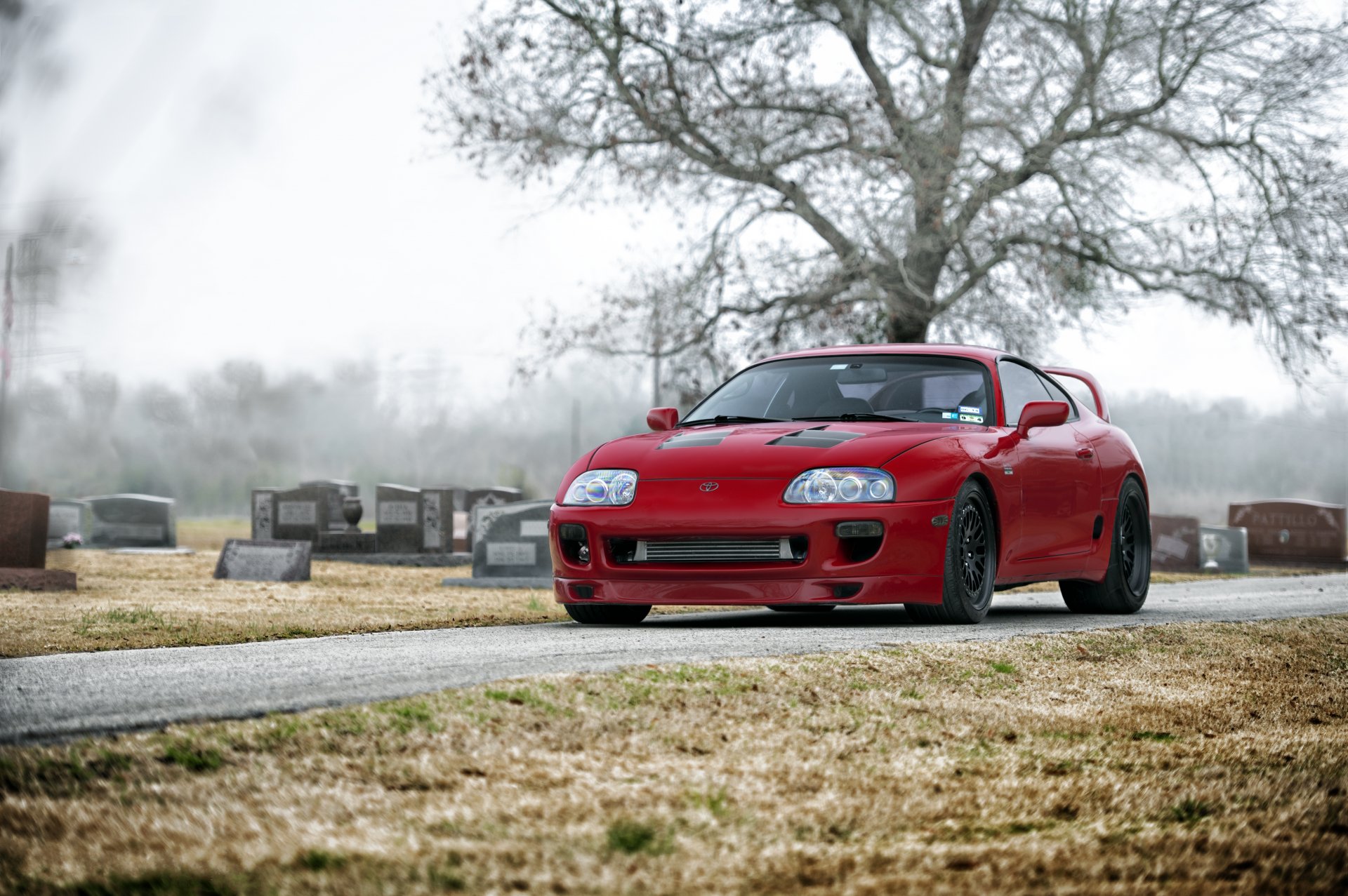 toyota above red toyota supra red cemetery grave