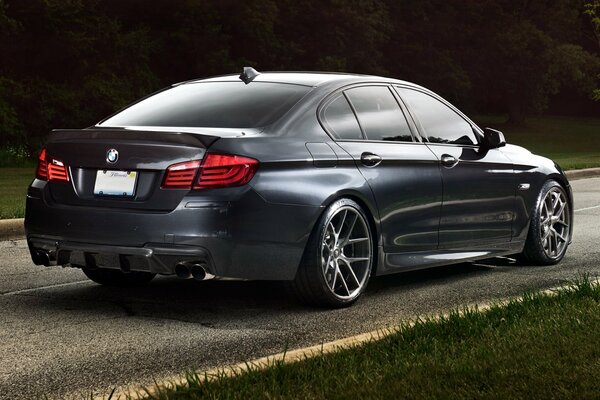 BMW 5 series rear view on the road