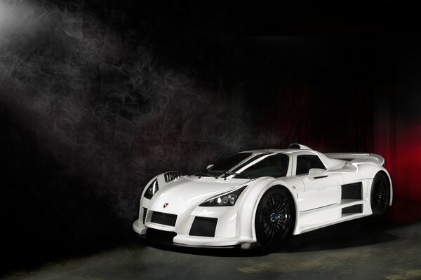 A beam of light is directed at the white supercar
