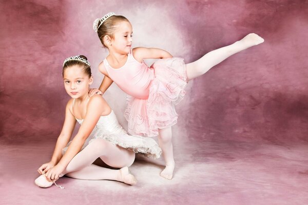 Ballerinas in tutus. Two girls on a purple background