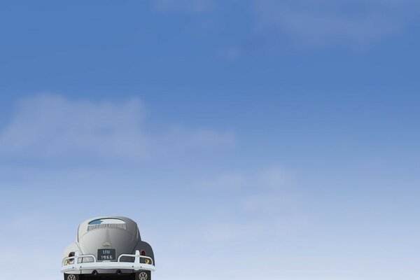 A car on the sand against a blue sky background