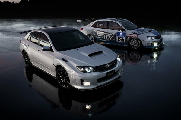 Two white cars in the water in the evening