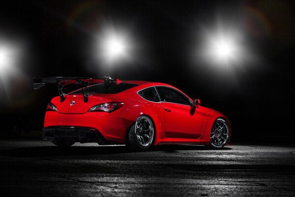 Red Hyundai car on the background of lanterns