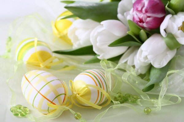 Easter eggs on the table with tulips