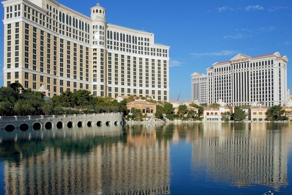 An architectural building of modern style against the background of blue sky and water