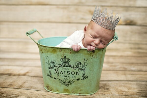 A wonderful baby sleeps in a stylish basin