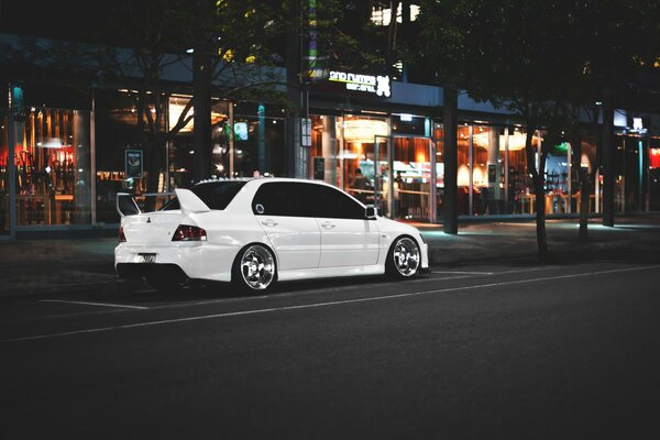 White Mitsubishi rides through the city