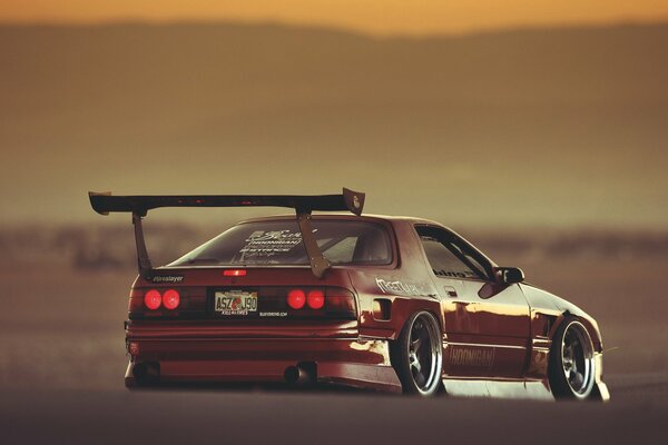 Orange racing mazda in the desert