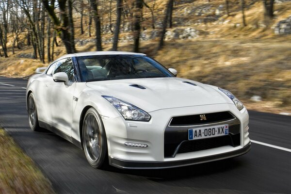 White beautiful car front view in motion