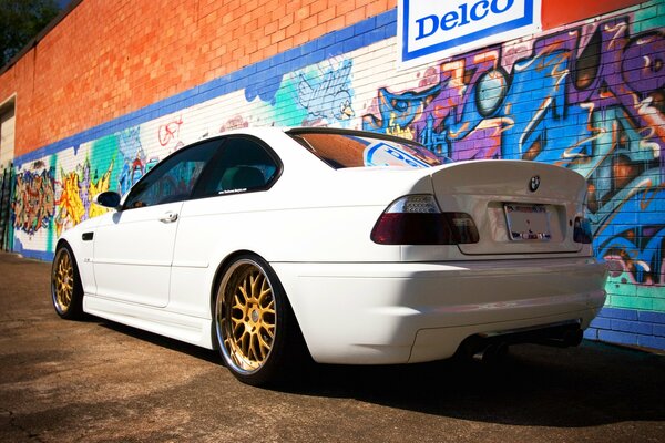 White BMW in tuning with gold wheels