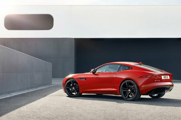 Red Jaguar car on a gray background