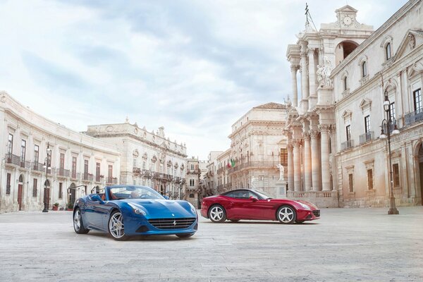 Blue and red cars on the background of ancient buildings