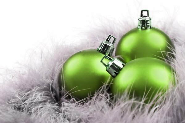 Green Christmas balls in white tinsel