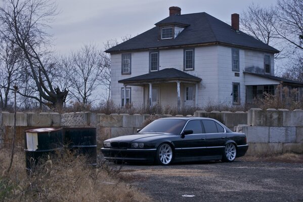 Black BMW on the background of the house