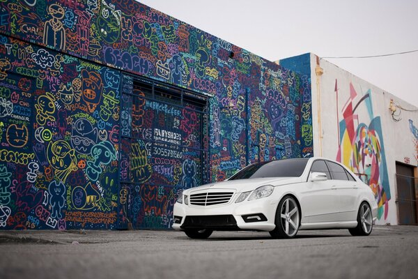 White Mercedes, graffiti on the wall