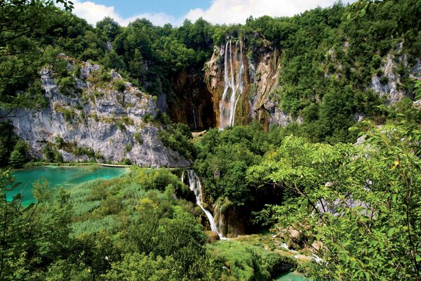 Beautiful nature. The waterfall flows into the lake