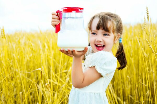 A girl in the field with a jug of milk