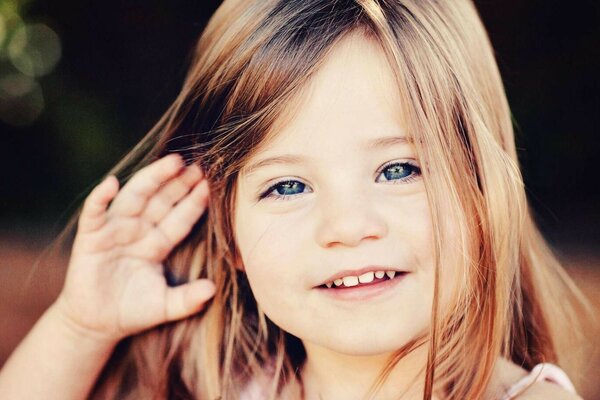 A child with blue eyes smiles