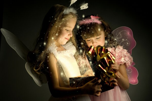 Fairy girls open a gift