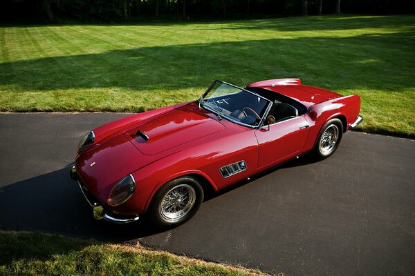 Old red Ferrari convertible on the lawn