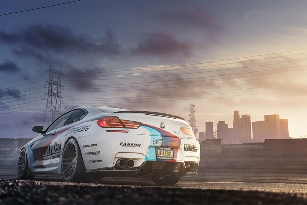 Bmw on the background of power lines and the sky