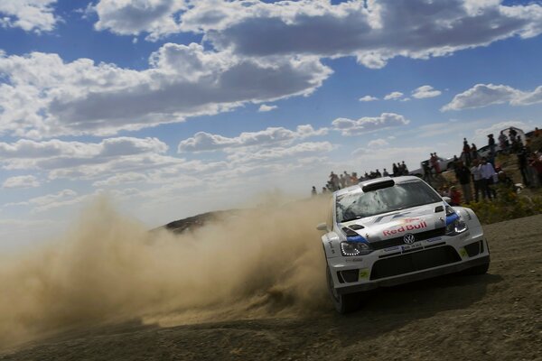 White Volkswagen Polo rushes down the road for a rally