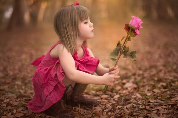 A girl with a rose and an autumn landscape