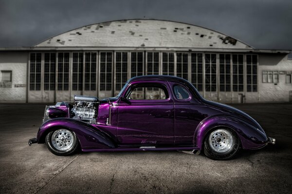Classic purple hot rod car on retro street