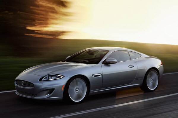 Silver Jaguar XK car in motion