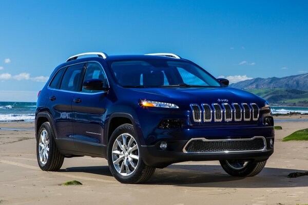 Blue jeep Cherokee on the background of the ocean