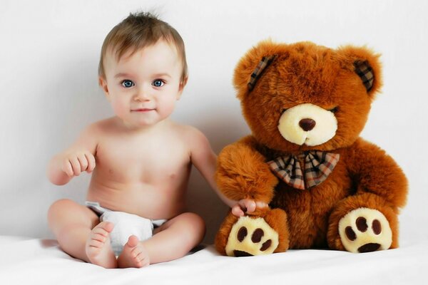 A small child with a toy. Soft bear
