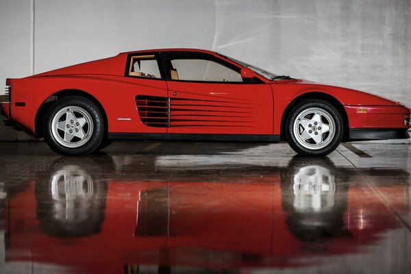 Red Ferrari Testarossa with reflection on the floor