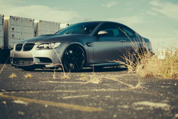 There is a beautiful gray car on the road