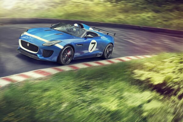 Blue jaguar on the race track in a turn